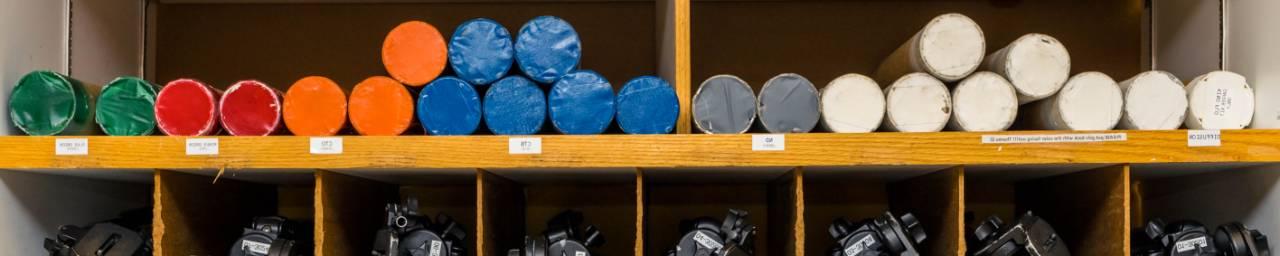 Colorful cardboard circles and tripods in rows